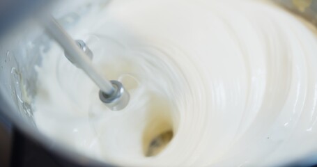 close up pastry chef hands mixing ingredients baking cream meringue with flour egg butter and sugar in a bowl, Preparing dessert in the kitchen, close up at automatic flour mixing machine