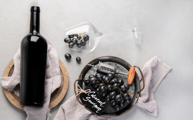 Red wine assortment with appetizers on light gray background.