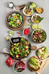 Vegan dishes assortment on gray background.