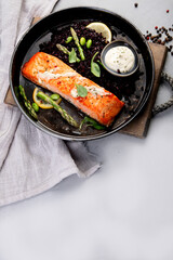 Fototapeta na wymiar Baked salmon with asparagus and black rice.