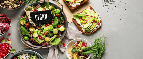 Vegan dishes assortment on gray background.