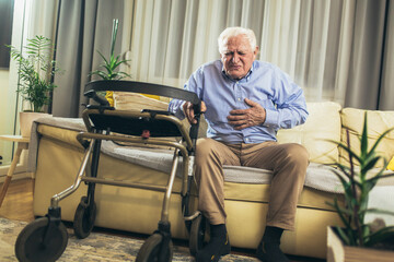 Fototapeta na wymiar Senior man with chest pain suffering from heart attack at home
