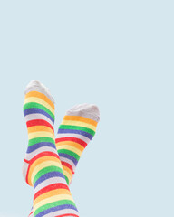 Bright colorful socks on blue background. Leisure concept.