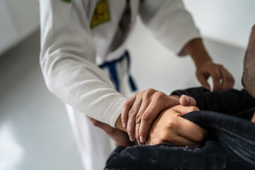 Obraz na płótnie Canvas Brazilian Jiu Jitsu BJJ close up on hands and grip on the kimono gi during training or sparing martial arts concept