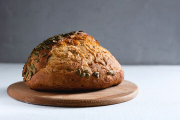 Rye bread on a board on a white tablecloth background