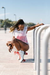 beautiful afro american woman posing with roller skates