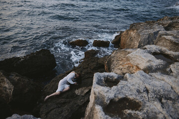 woman in white wedding dress on sea shore wet hair view from above