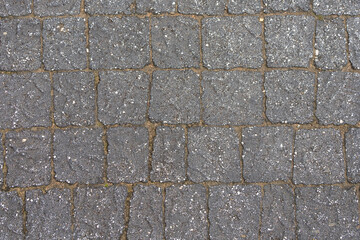 The wall is paved with gray stones, top view. stone texture, outdoor stone tiles