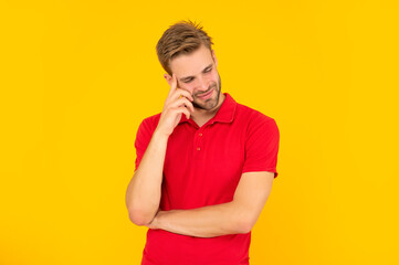 cheerful unshaven young man in red shirt on yellow background, skincare