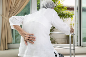 Asian senior patient with lower back pain or back muscle injury,old elderly having backache,painful...