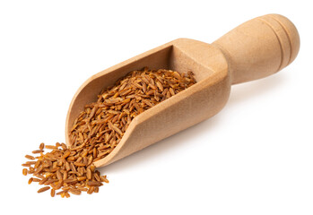 Roasted cumin seeds in the wooden scoop, isolated on the white background.