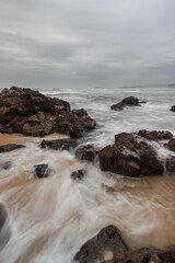 Rocky beach shore with overcast sky.