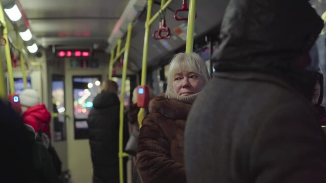 caucasian woman wearing fur coat going by city bus. footage with sekective focus and noise effect