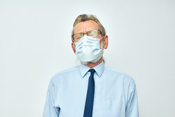Senior grey-haired man in shirt with tie medical mask safety isolated background