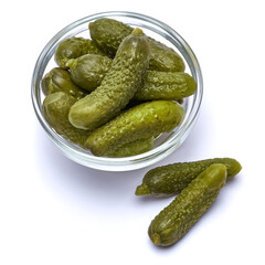 Bowl of Tasty canned Whole green cornichons isolated on a white background