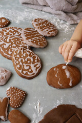 Obraz na płótnie Canvas Girl makes homemade gingerbread cookies for Easter