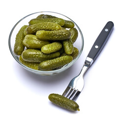 Bowl of Tasty canned Whole green cornichons isolated on a white background