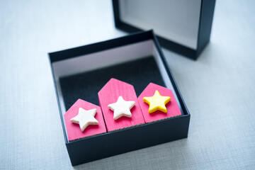 Three red houses in box with rating star. Symbol of successful choice.