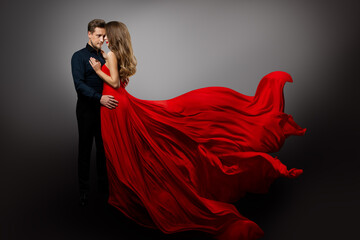 Romantic Couple in Love dancing. Man in Black Shirt Embracing Mysterious Girl in Flying Red Dress....