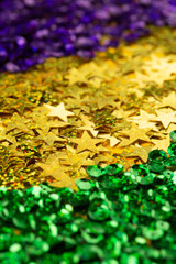 Shiny green, purple and golden glittering background for Mardi Gras holiday.