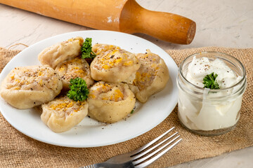 Lazy manti with meat and vegetables, fried dough stuffed with meat and snail-shaped pumpkin.