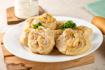 Boiled dough in the shape of a snail stuffed with meat and vegetables. Lazy manti.