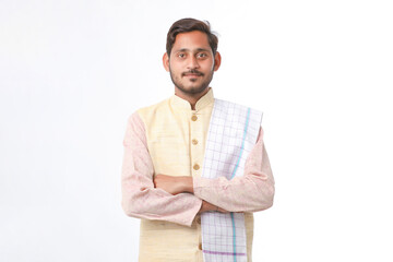 Young indian man in traditional wear and giving expression on white background. - obrazy, fototapety, plakaty
