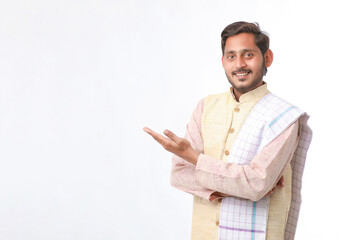 Young indian man in traditional wear and giving expression on white background.