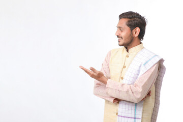 Young indian man in traditional wear and giving expression on white background.