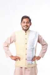 Young indian man in traditional wear and giving expression on white background.