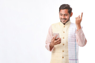 Young indian farmer using smartphone on white background.