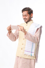 Young indian farmer using smartphone on white background.