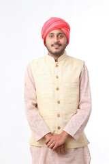 Young indian man in traditional wear and giving expression on white background.