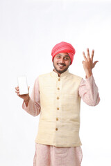 Young indian man showing smartphone and giving expression on white background.