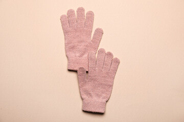 Obraz premium Pair of warm gloves on color background