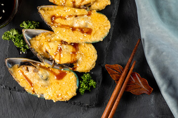 Mussels baked with cheese top view.