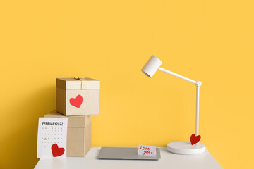 Gifts for Valentine's Day with laptop on table in room
