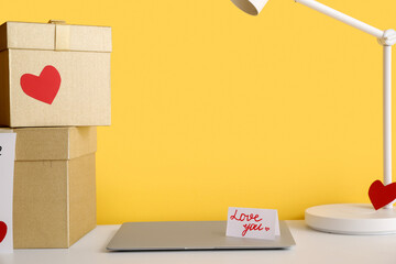 Gifts for Valentine's Day with laptop on table in room