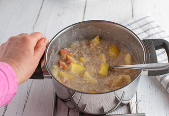 light food with a fresh cooked oatmeal porridge, cooked with water and apples