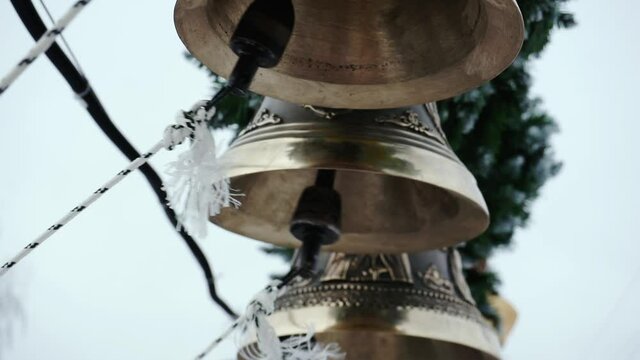 The bell-ringer pulls the strings of several bells.