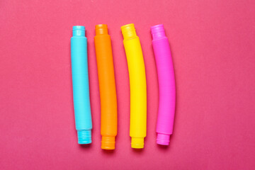 Different Pop Tubes on color background