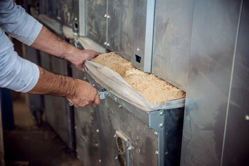 a carpenter empties the containers of an extractor or exhaust system