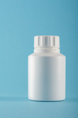 Blank medicine bottle on blue background