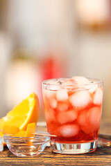 Glass of tasty Negroni cocktail on table against blurred background
