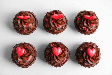 Tasty chocolate cupcakes for Valentine's day on light background