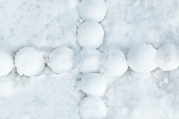Group of snowballs on a textured snow background.