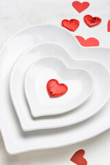 Fototapeta na wymiar Beautiful heart shaped plates on white background, closeup