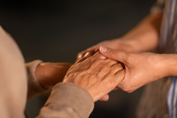 people, family and charity concept - close up of women holding hands