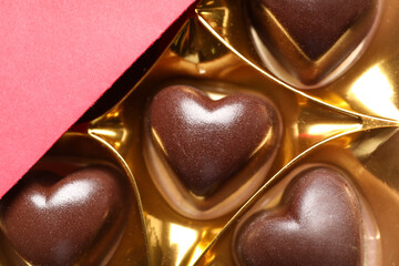 Box with tasty heart-shaped candies, closeup