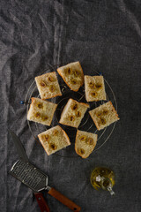 traditional baguette toasts baked with cheese, olives and olive oil.